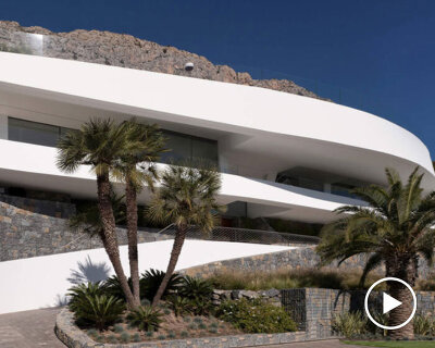 curved house's sinuous facade traces mountainous terrain in spain