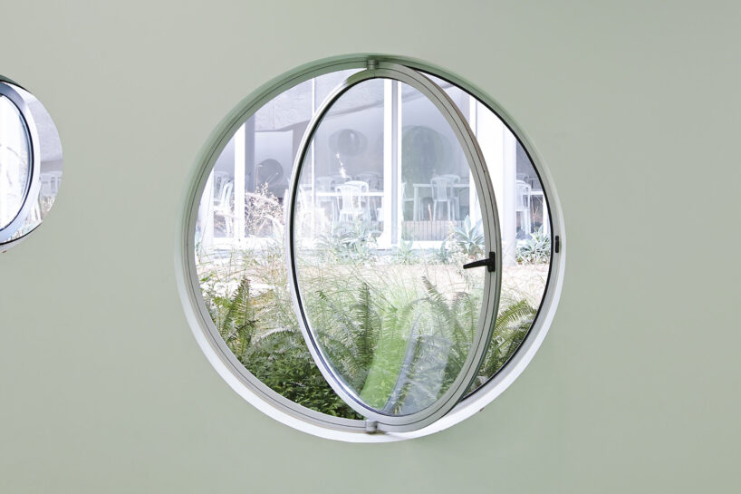 circular colored openings pierce through concrete facade of school extension in lebanon