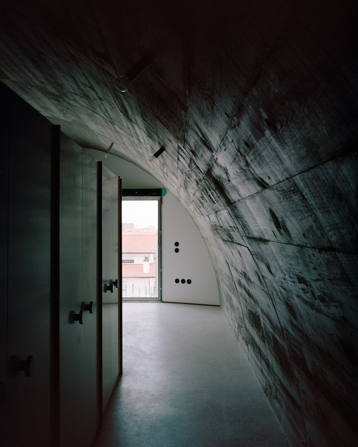 fala atelier inverts the sloped roof with slants and curves for this sculptural home in portugal