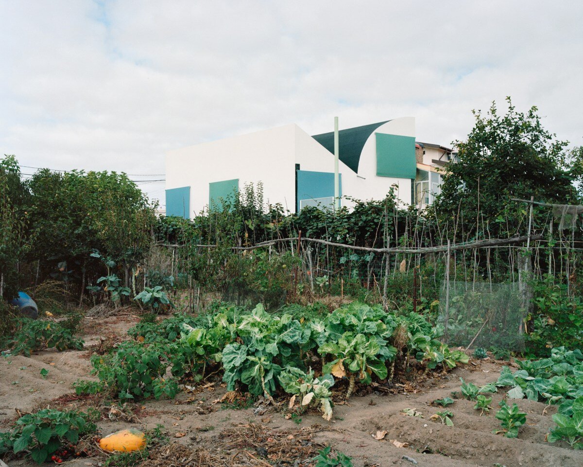 fala atelier inverts the sloped roof with slants and curves for this sculptural home in portugal