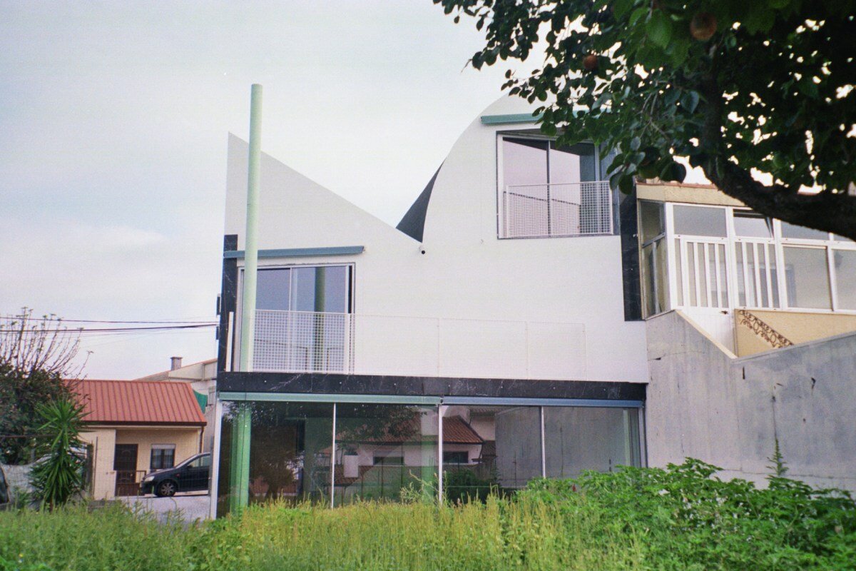 fala atelier inverts the sloped roof with slants and curves for this sculptural home in portugal