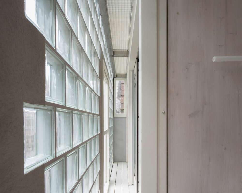 delmulle delmulle's gradient brick facade shifts from terracotta to glass in amsterdam townhouse