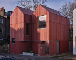 monochromatic facade wraps graeme williamson's dual-gabled 'twin house' in london