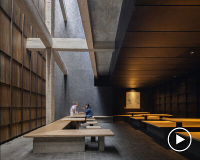 light and rain pour through internal courtyard within monochrome dessert shop in indonesia