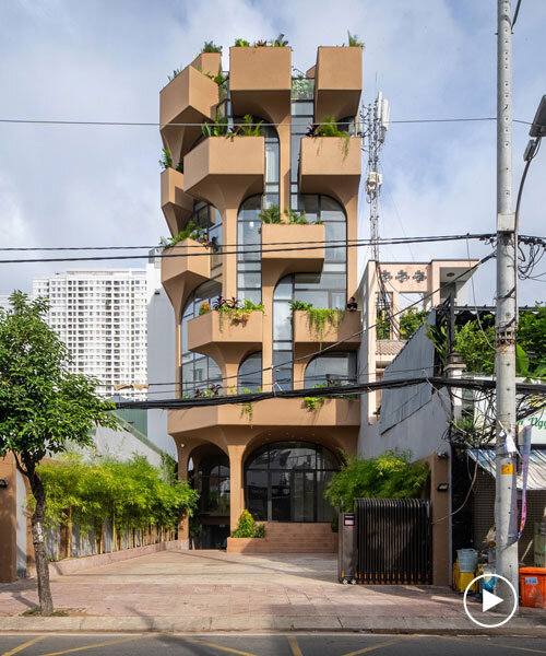 mixed-use unit's curved and vaulted volumes by room+ shape vertical garden in vietnam