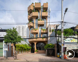 mixed-use unit's curved and vaulted volumes by room+ shape vertical garden in vietnam