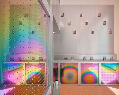iridescent titanium panels cast chromatic reflections within info desk by KOGAA in brno