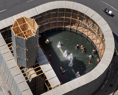 leopold banchini's temporary timber bathhouse reclaims traffic roundabout in spain