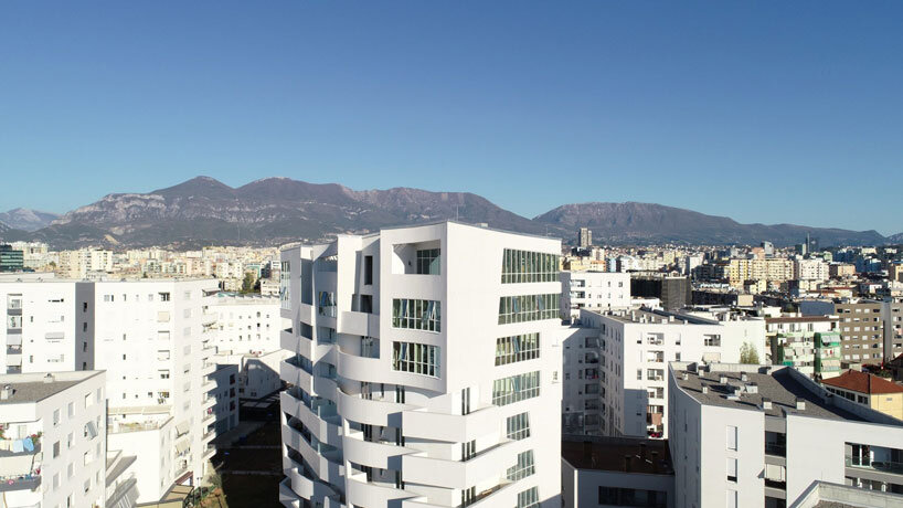 studio libeskind & kontakt weave public gardens through curved residences in tirana
