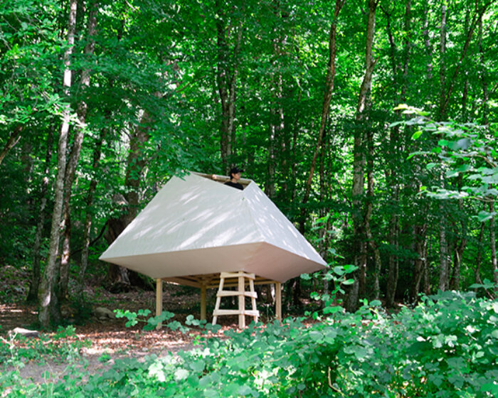 meaningless architecture's meditation cabin lights up like a lantern in french woodlands