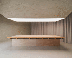modular wooden table reforms into exhibition platform within ceramic workshop by AACM