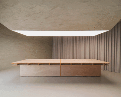 modular wooden table reforms into exhibition platform within ceramic workshop by AACM