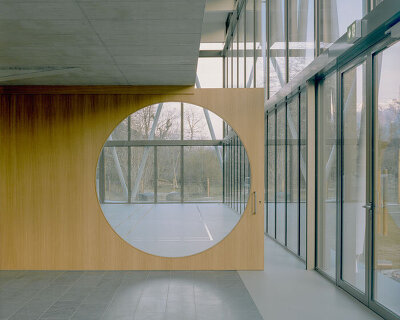 lattice of beams enfolds multipurpose gymnasium's facade in switzerland by demattè fontana