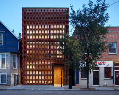 brick facade shrouds range-designed NDC furniture studio headquarters in chicago