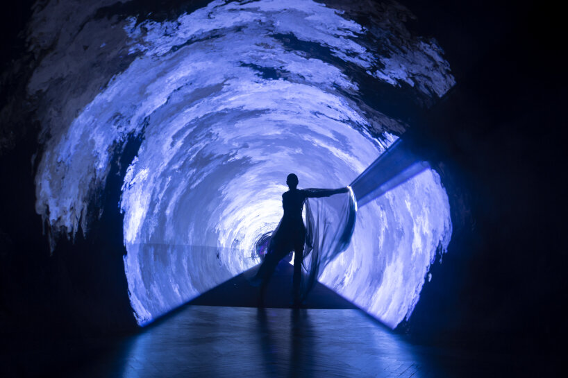 a biosphere light portal grows around the models on the runway