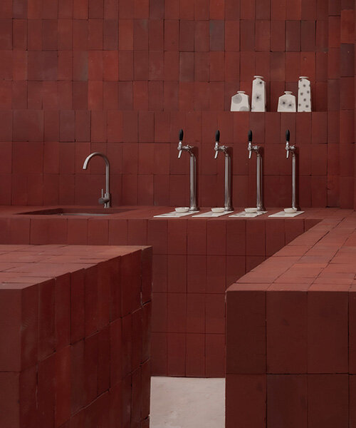 red bricks line the refreshment club's kiln-inspired flagship for parisian porcelain house