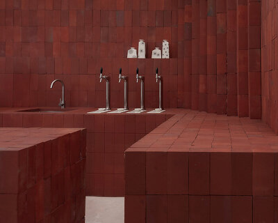 red bricks line the refreshment club's kiln-inspired flagship for parisian porcelain house