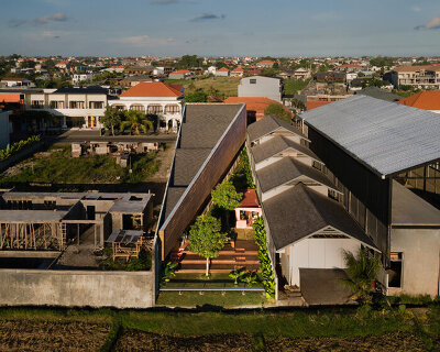 restaurant by studio kota cascades down balinese terrain in a series of open-air platforms