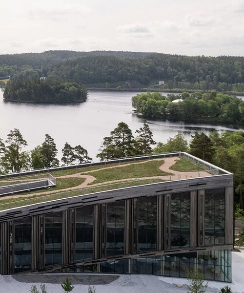 snøhetta's wendelstrand lakehouse resembles a moss-covered spine in sweden