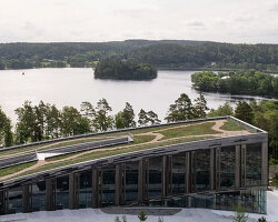 snøhetta's wendelstrand lakehouse resembles a moss-covered spine in sweden