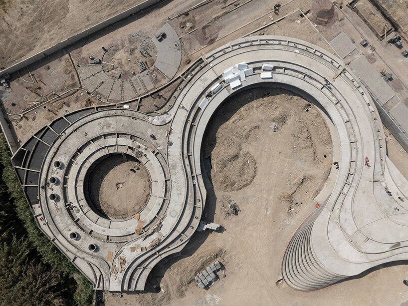 sordo madaleno embeds circular school into volcanic terrain at the foot of mexican pyramid