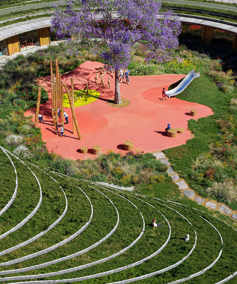 sordo madaleno embeds circular school into volcanic terrain at the foot of mexican pyramid
