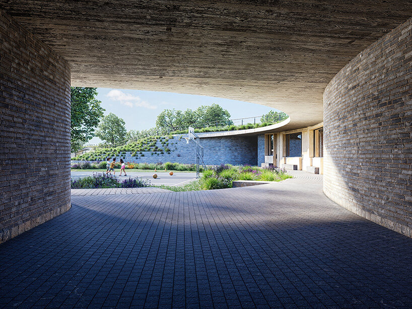 sordo madaleno embeds circular school into volcanic terrain at the foot of mexican pyramid