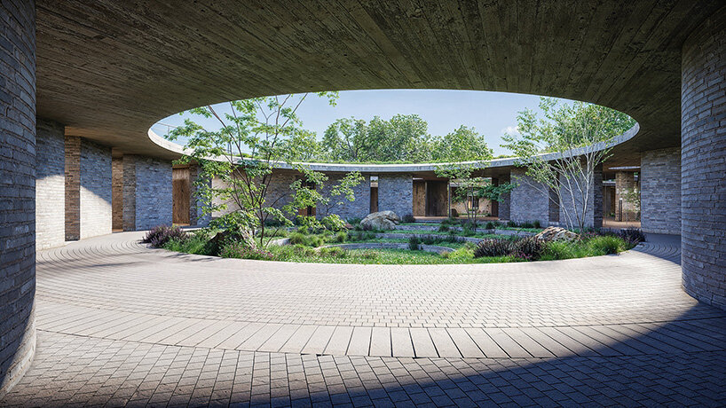 sordo madaleno embeds circular school into volcanic terrain at the foot of mexican pyramid