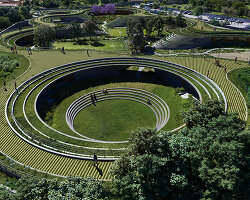 sordo madaleno embeds circular school into volcanic terrain at the foot of mexican pyramid
