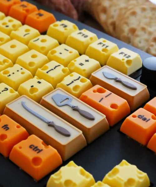 swiss cheese mechanical keyboard types with caps shaped like grater, knives and jar of jam