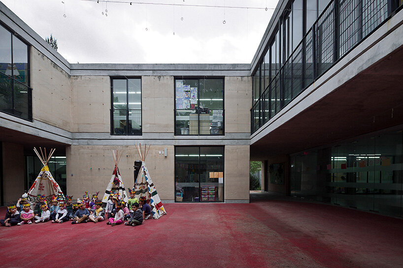 tatiana bilbao shapes rammed earth preschool in mexico around central tree
