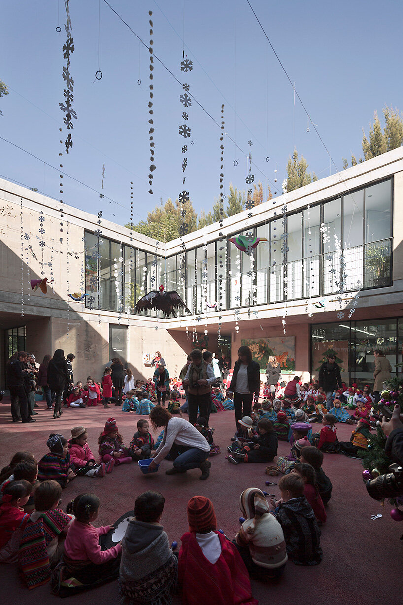 tatiana bilbao shapes rammed earth preschool in mexico around central tree