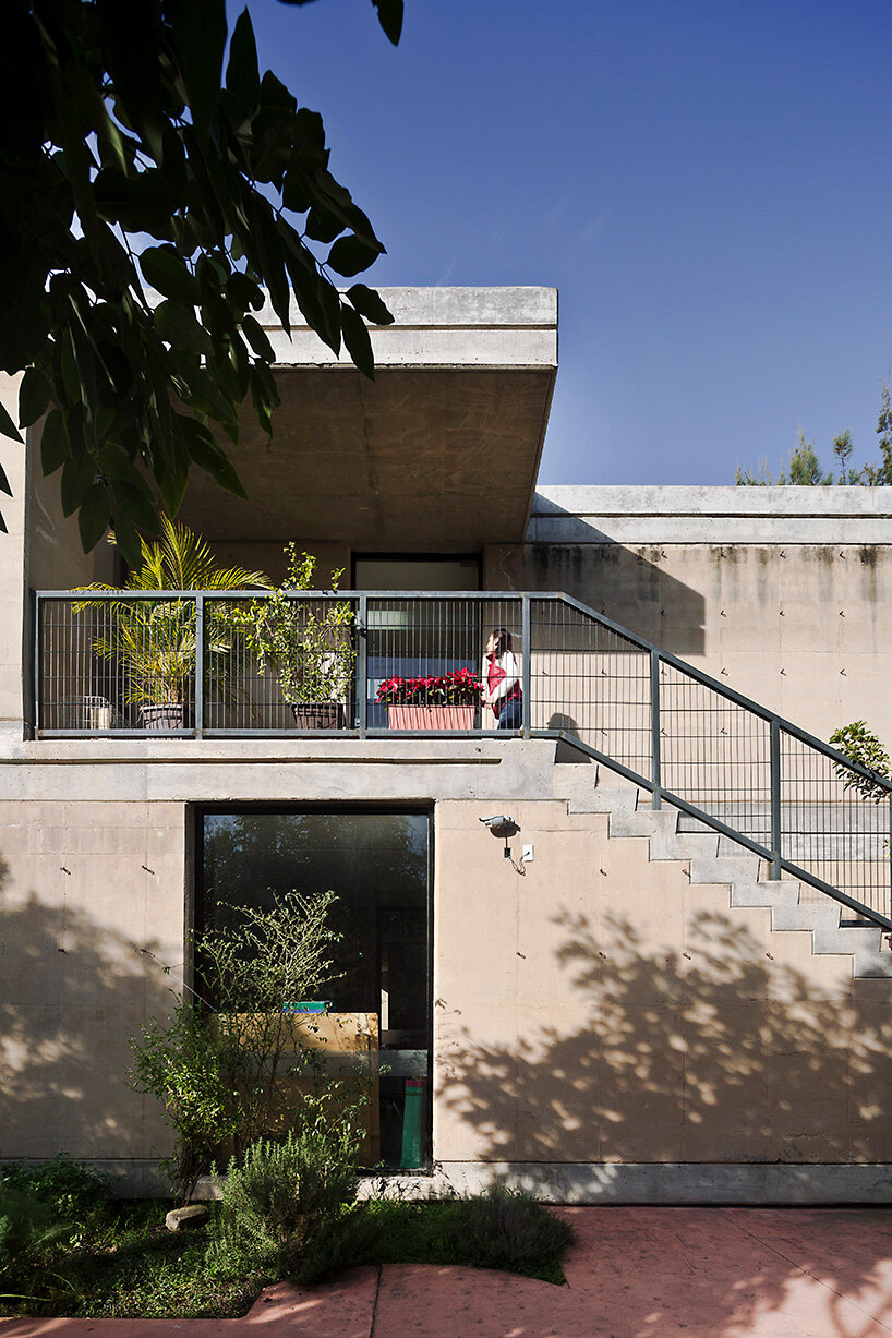 tatiana bilbao shapes rammed earth preschool in mexico around central tree