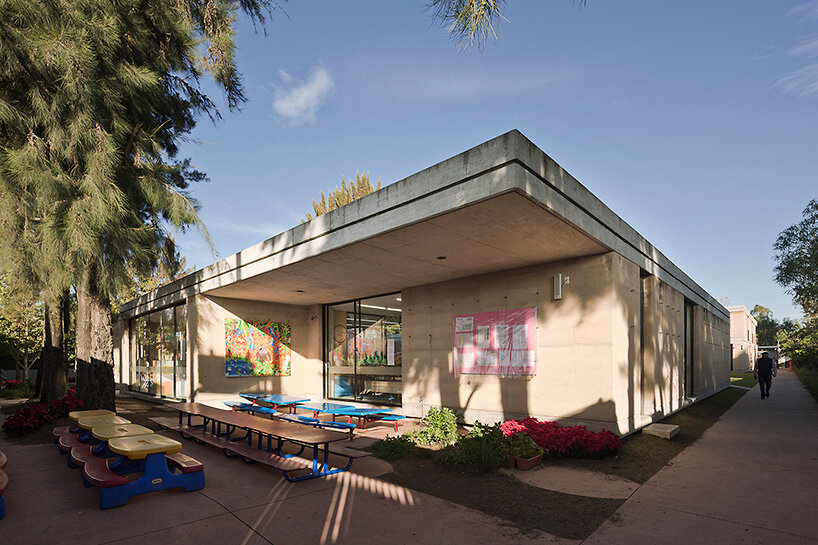 tatiana bilbao shapes rammed earth preschool in mexico around central tree