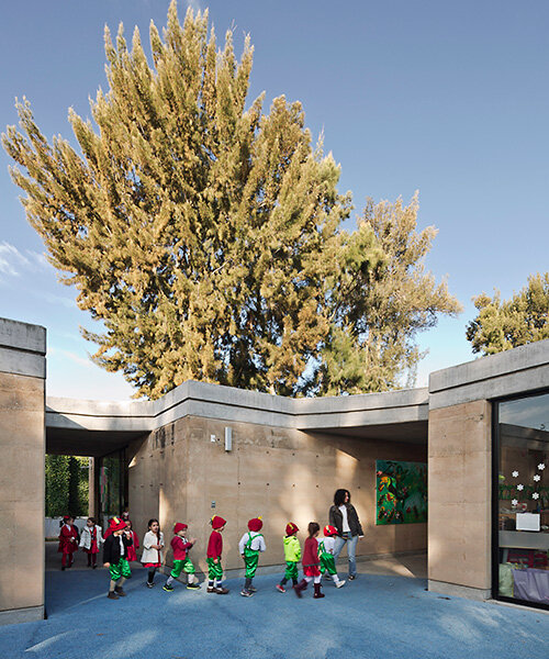 tatiana bilbao shapes rammed earth preschool in mexico around central tree