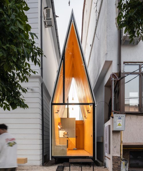 vinklu inserts triangular prism into narrow urban gap for coffee shop in romania