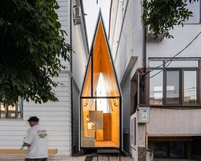 vinklu inserts triangular prism into narrow urban gap for coffee shop in romania