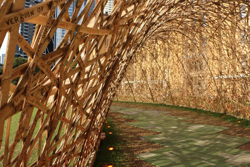 thousands of hand-split bamboo strands weave curved tunnel by cave urban in sydney