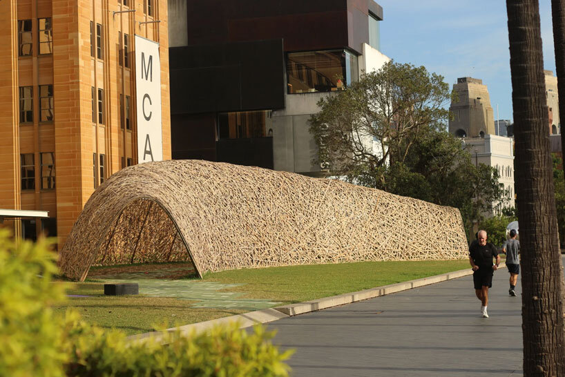 thousands of hand-split bamboo strands weave curved tunnel by cave urban in sydney