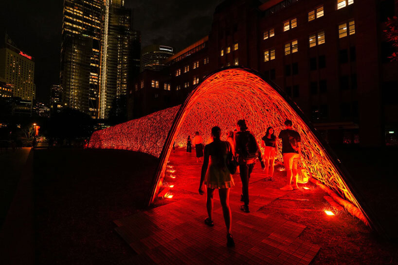 thousands of hand-split bamboo strands weave curved tunnel by cave urban in sydney