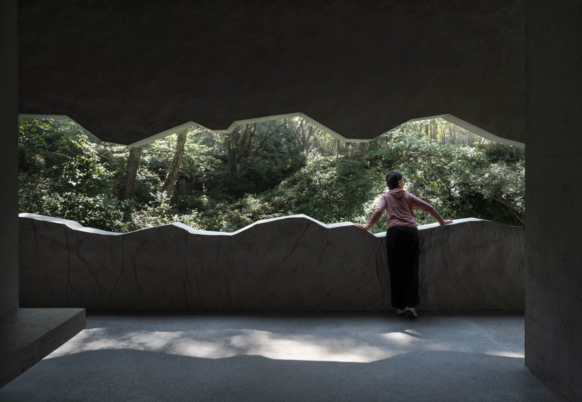 WUWU atelier's restrooms perch like concrete clouds and cavernous crevices in china forest