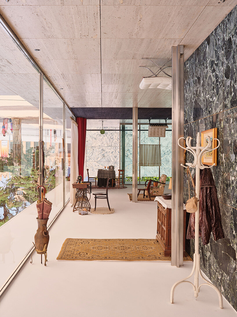 xevi bayona flips mies van der rohe's barcelona pavilion with ceiling-bound household relics
