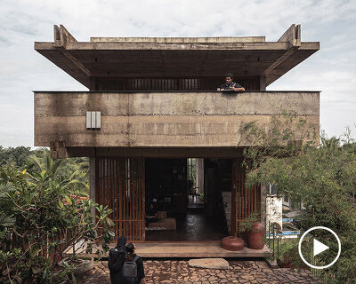 hybrid office-residence extends raw concrete balcony above recessed timber mass in india