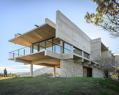 cristian nanzer’s house on el dragón rises from cyclopean stone base in argentina