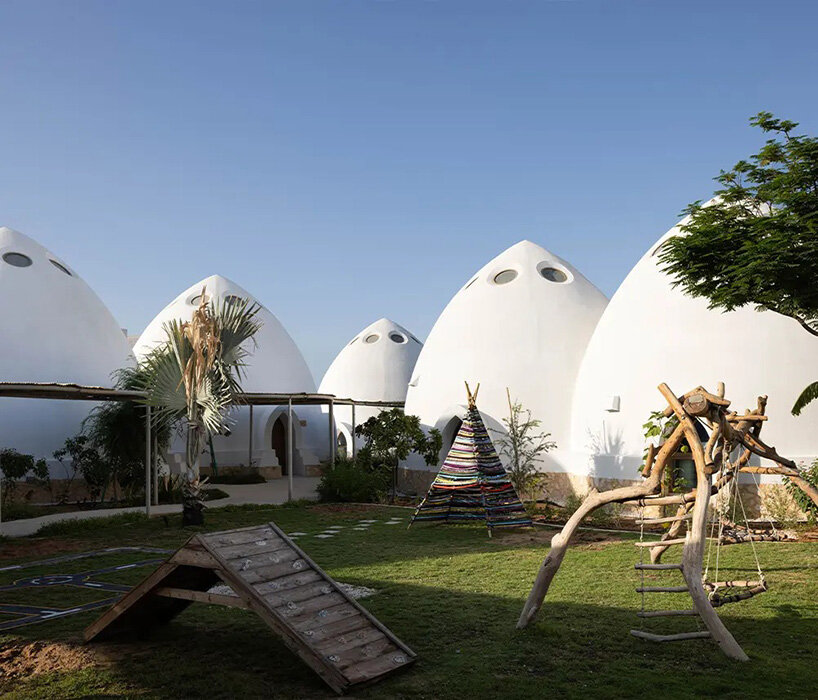 circular skylights punctuate all-white dome structures of EMKAAN's al fanar school in dubai