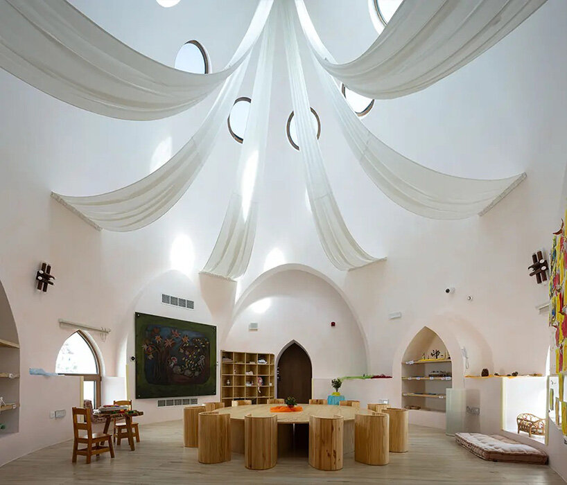 circular skylights punctuate all-white dome structures of EMKAAN's al fanar school in dubai
