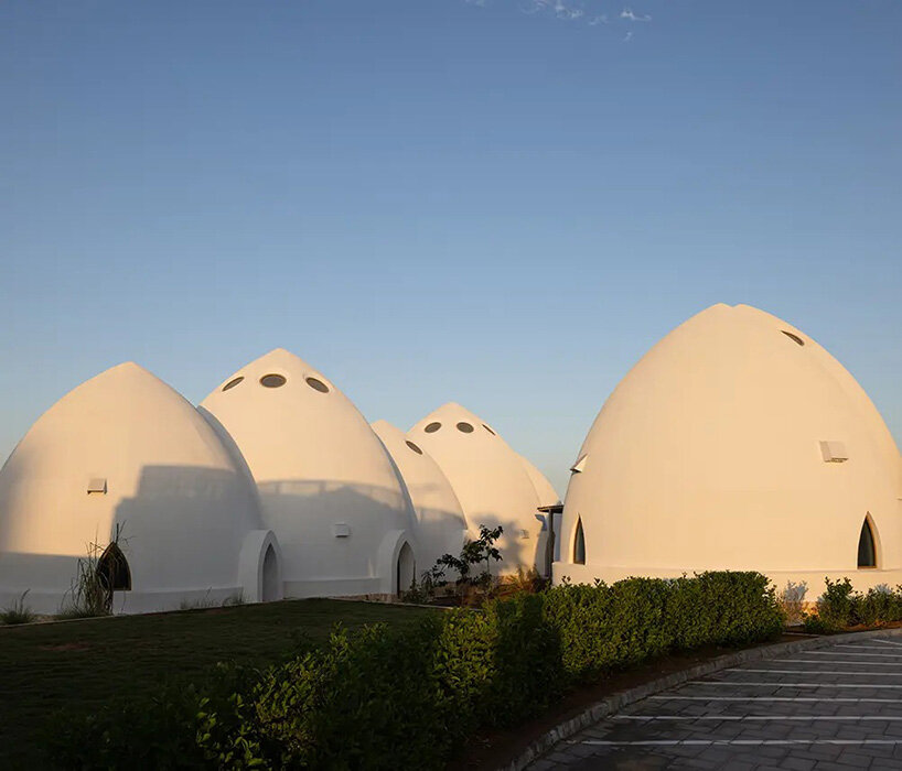 circular skylights punctuate all-white dome structures of EMKAAN's al fanar school in dubai