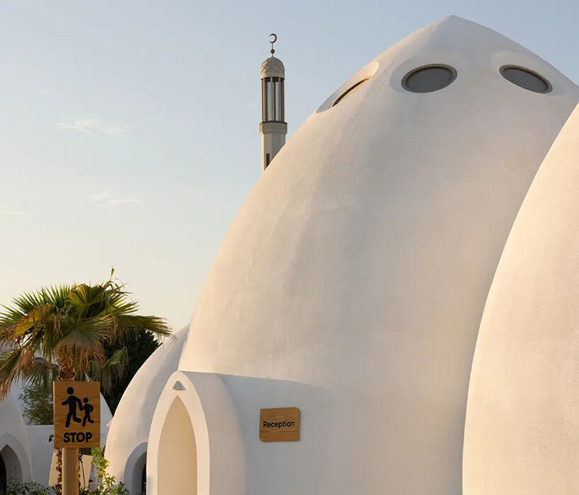 circular skylights punctuate all-white dome structures of EMKAAN's al fanar school in dubai