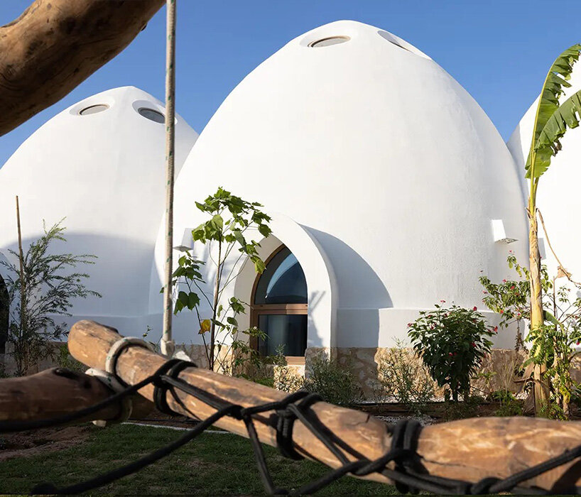circular skylights punctuate all-white dome structures of EMKAAN's al fanar school in dubai