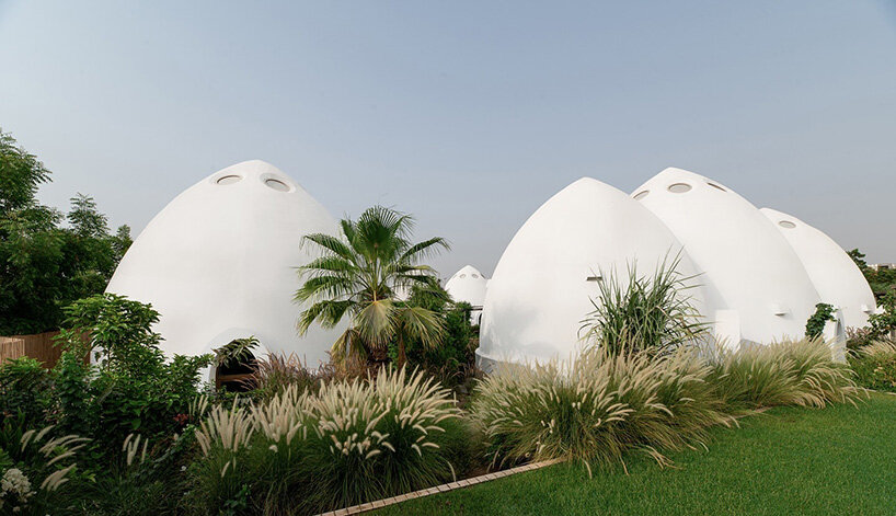circular skylights punctuate all-white dome structures of EMKAAN's al fanar school in dubai